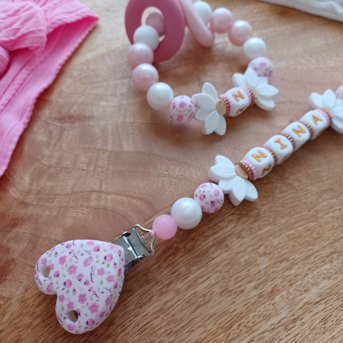 Attache tétine en silicone, pratique et sécurisée, idéale pour maintenir la tétine du bébé propre et à portée de main. Parfait comme cadeau de naissance.