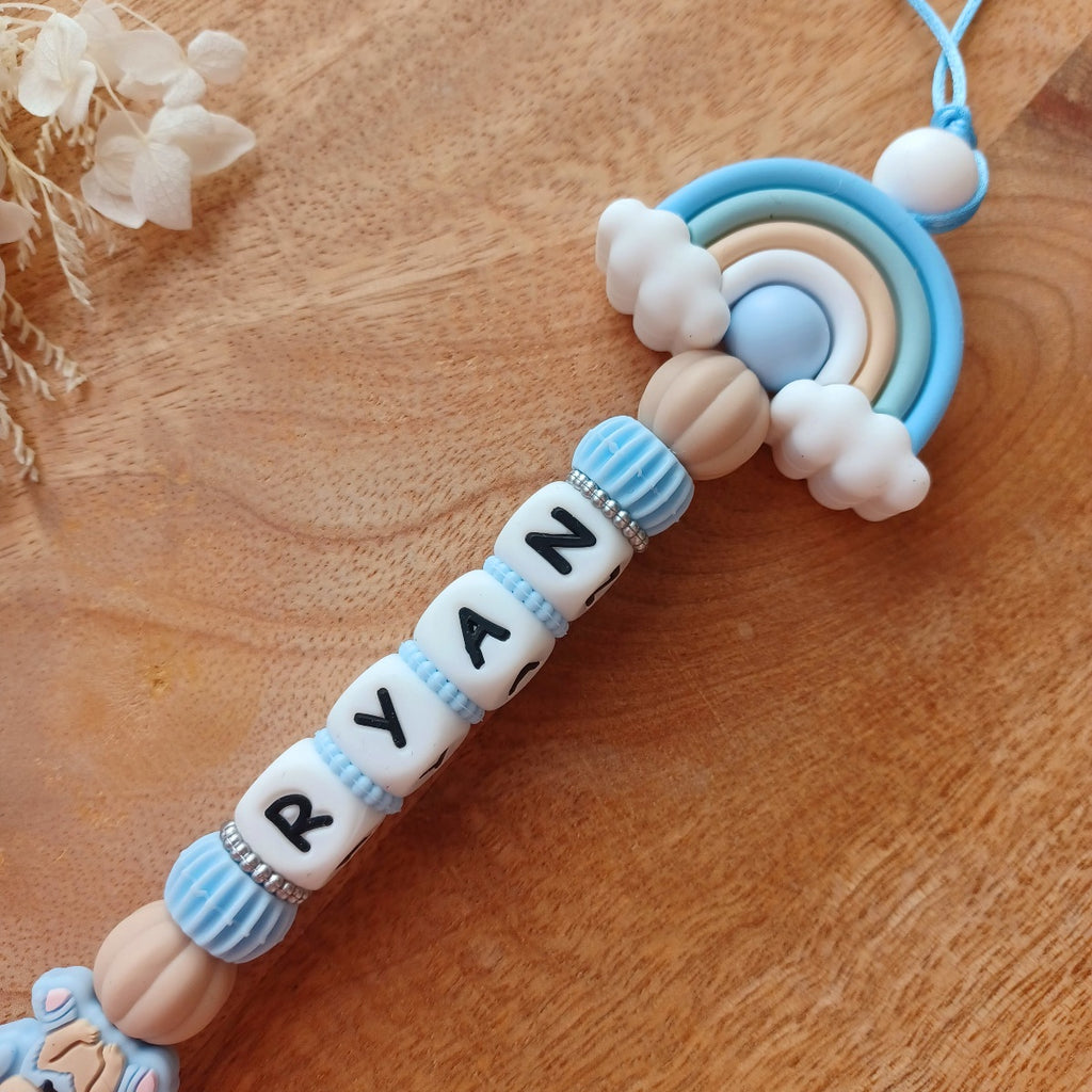 Attache tétine silicone, arc en ciel, bleu . Ryan