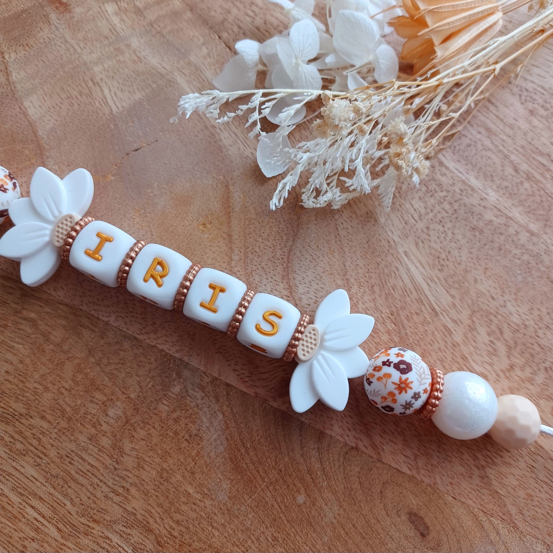 Attache tétine silicone, Fleur lotus blanc, crème. Iris