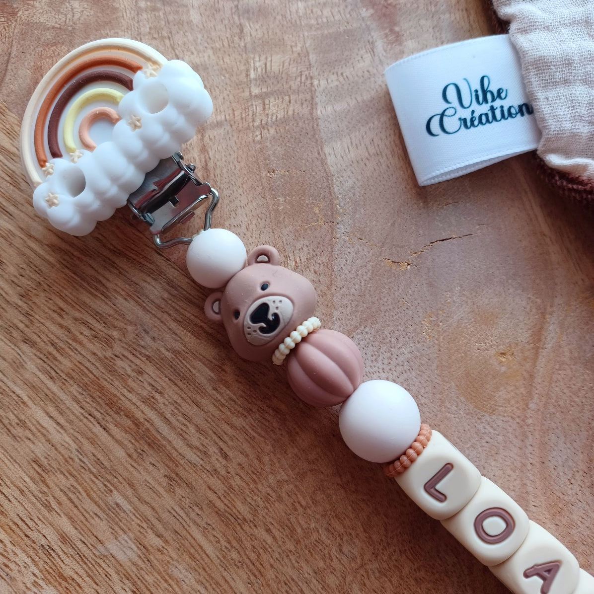 Attache tétine silicone Ours marron, crème-choco. Loan.