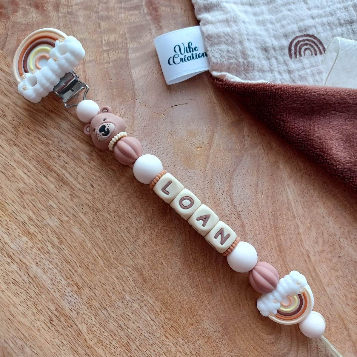 Attache tétine silicone Ours marron, crème-choco. Loan.