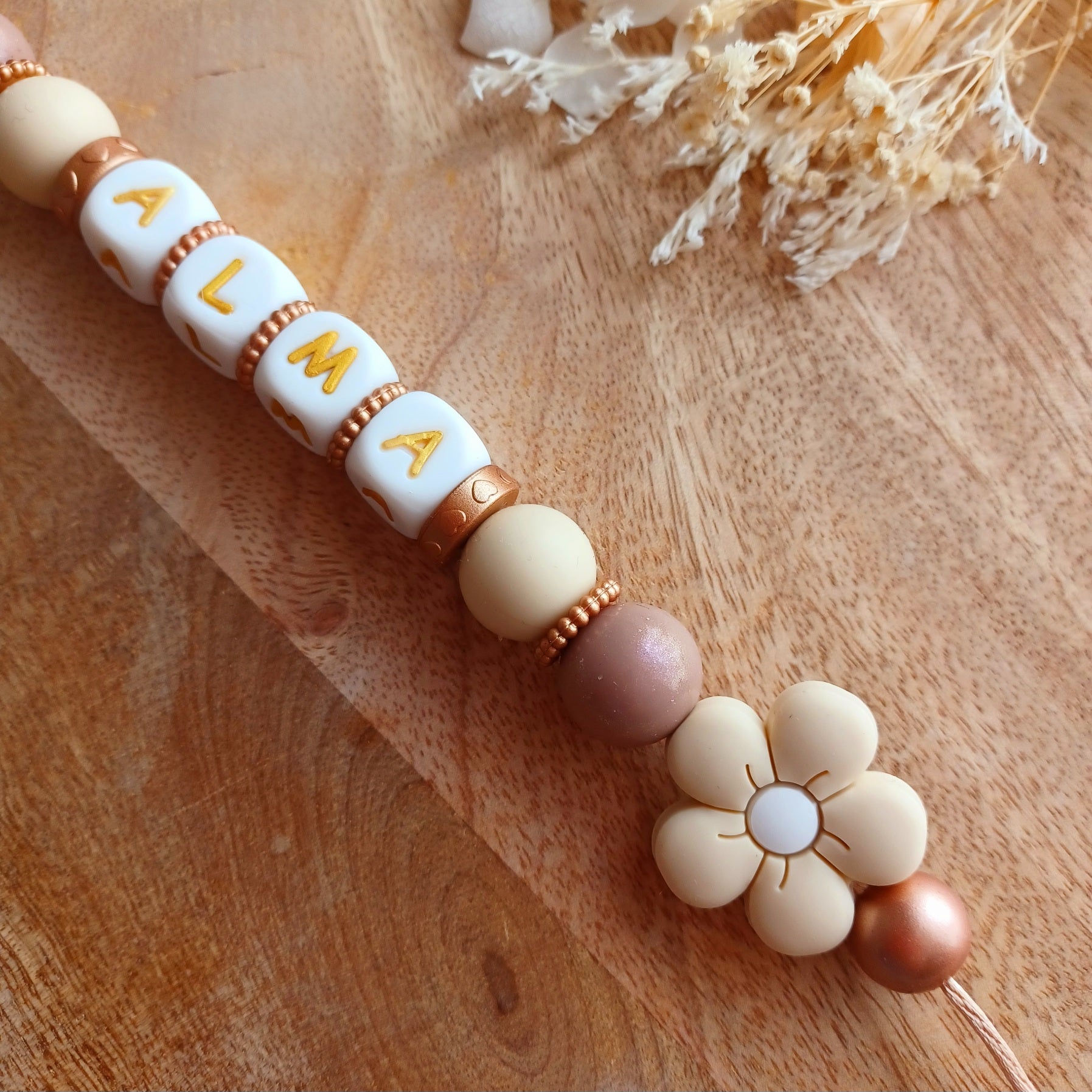 Attache tétine silicone, Fleur crème-chocolat.