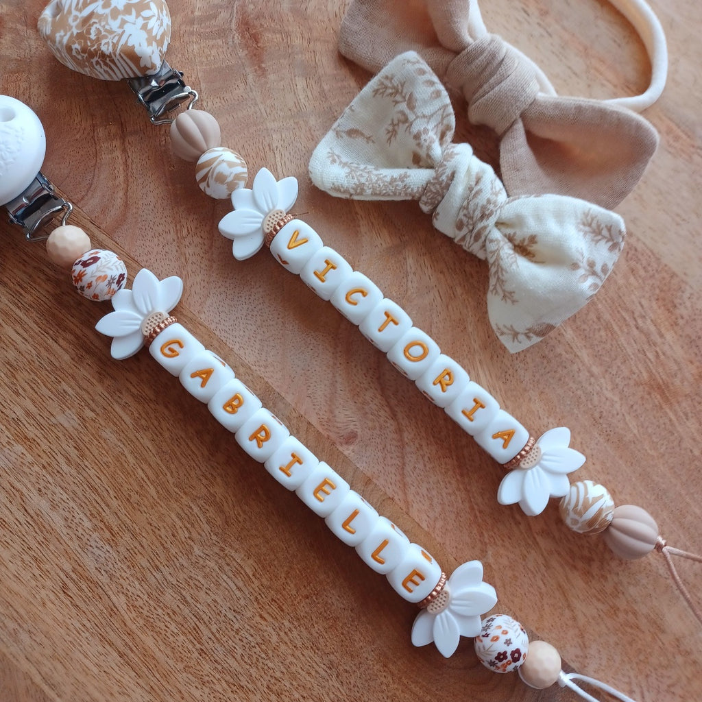 Attache tétine silicone, Fleur lotus blanc, crème. Iris